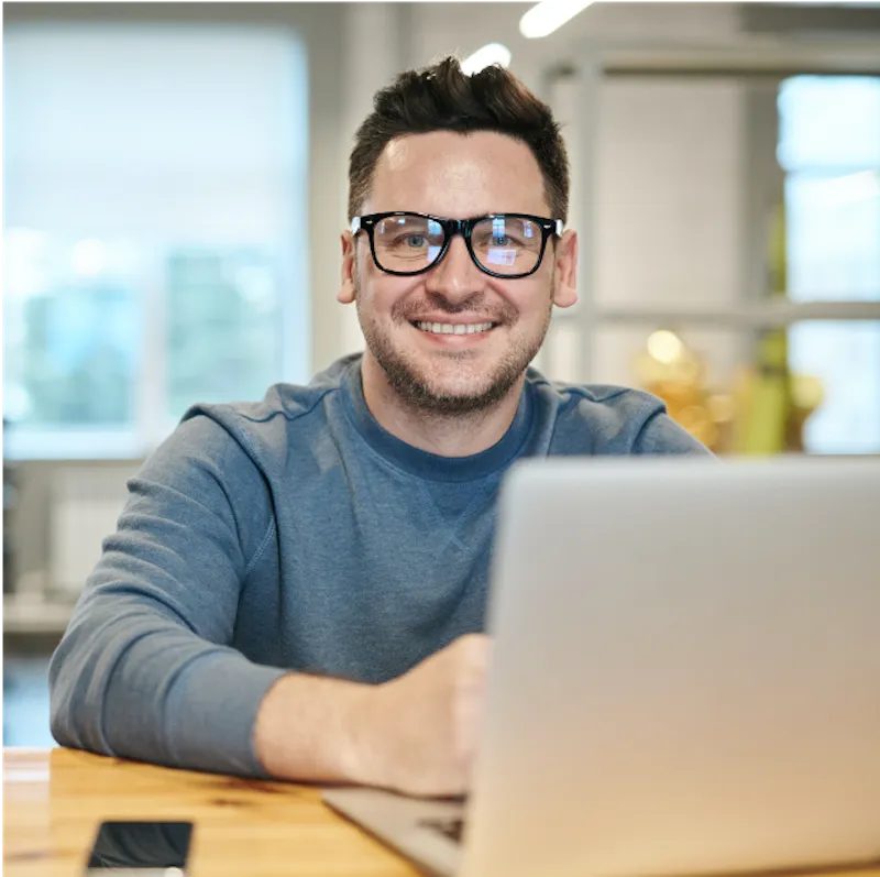 smiling man on laptop