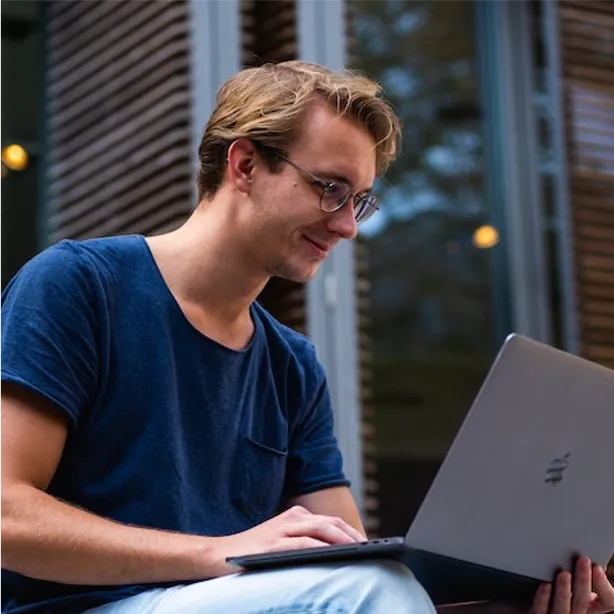 happy man looking at laptop