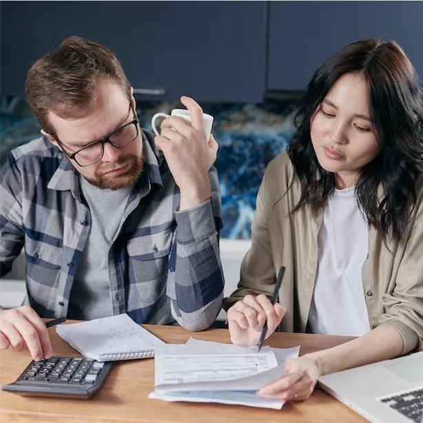 man and woman looking at checkbook