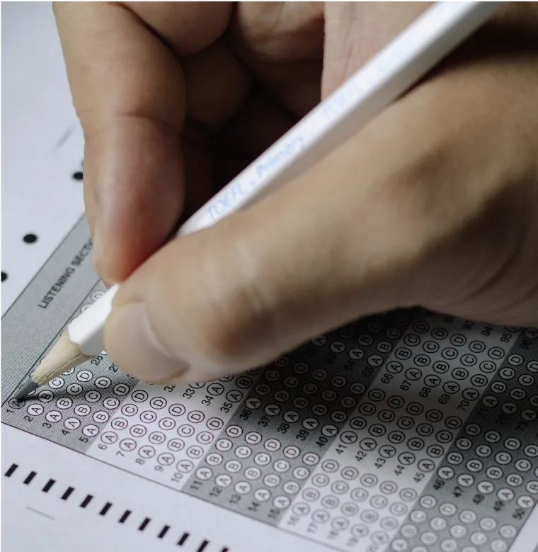 hand holding white pencil filling in bubble form