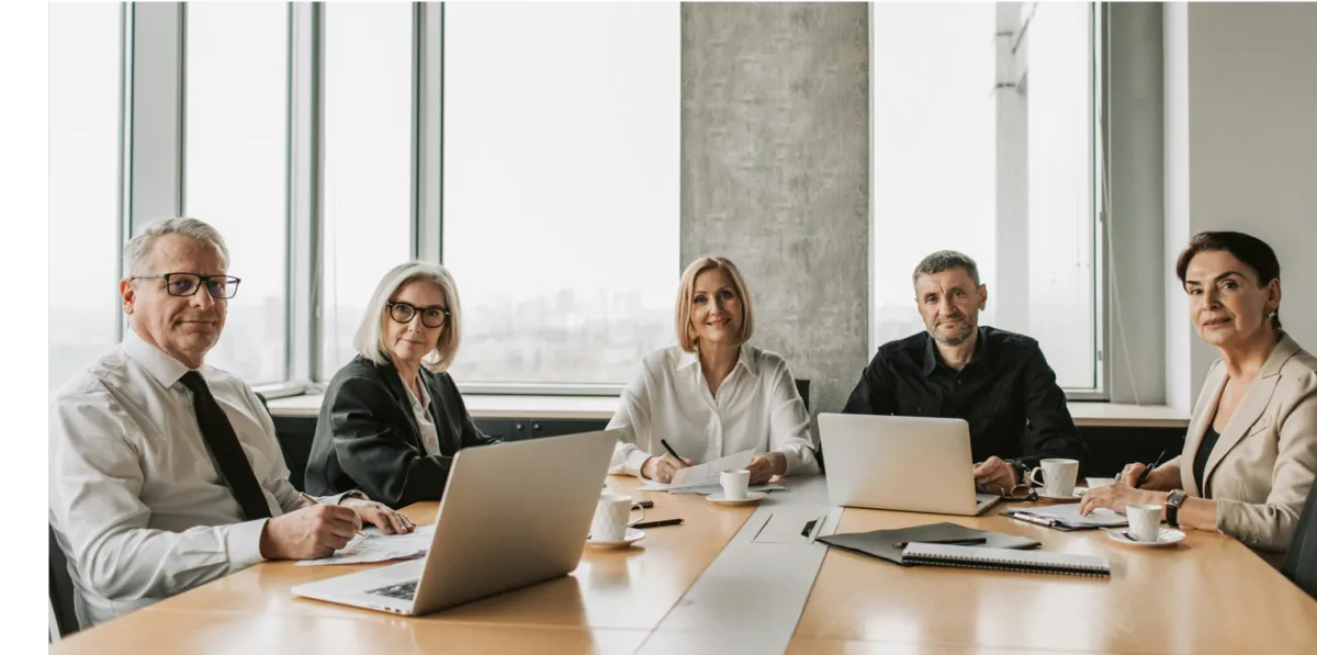 Professional employees collaborating in a modern office — fragrance-free workplace sprays help maintain focus and calm without downtime or workshops.