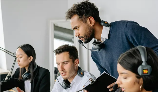 Office team using headsets focused on tasks — Calm Work Solutions unscented workplace spray kits support stress reduction and productivity in corporate and government environments.