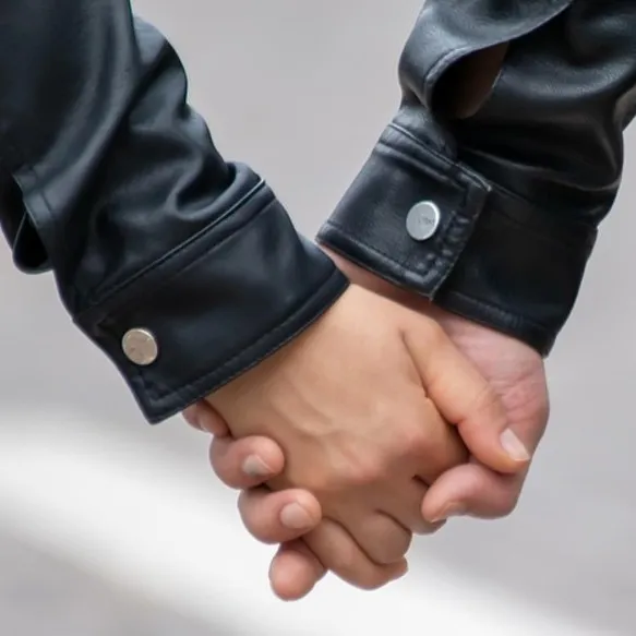 a man and woman holdig hands