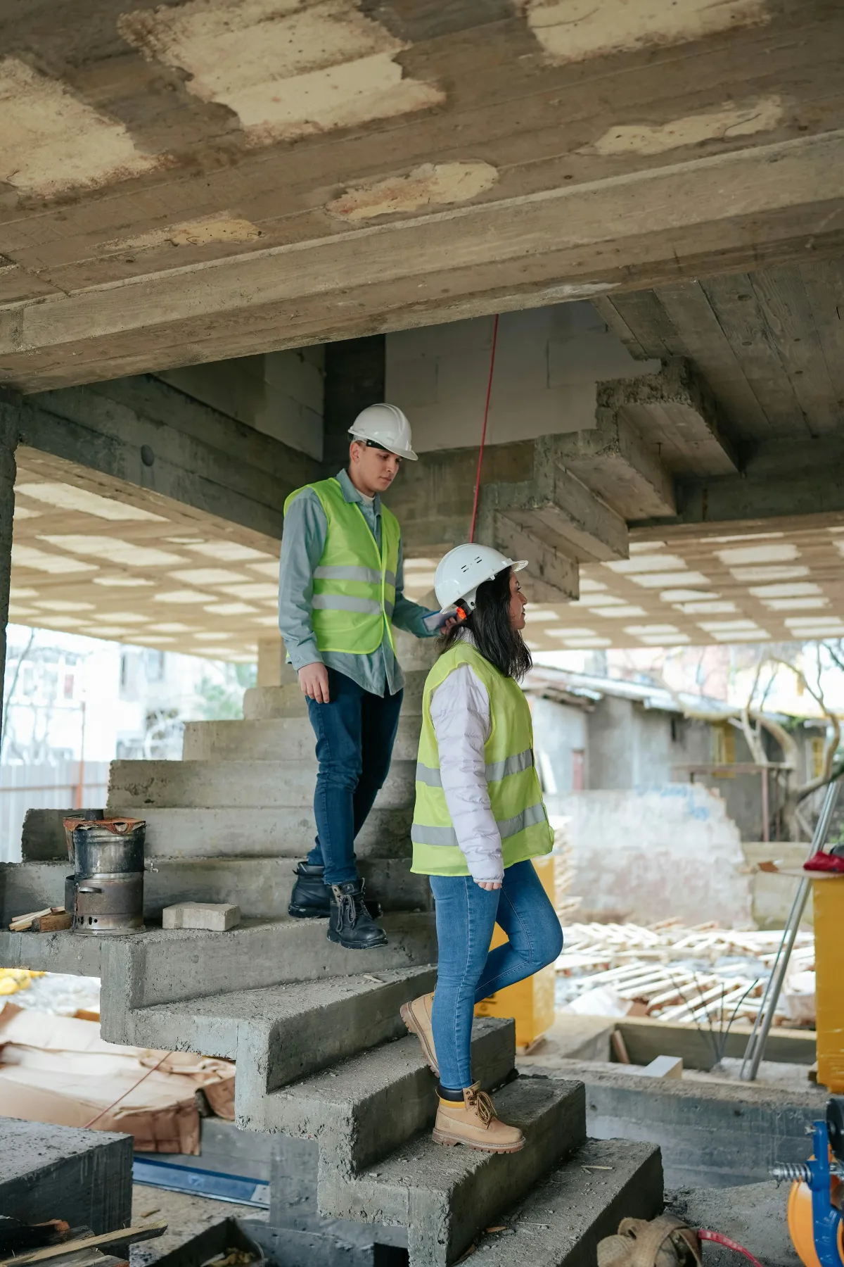 construction workers in hard hats walking around a jobsite