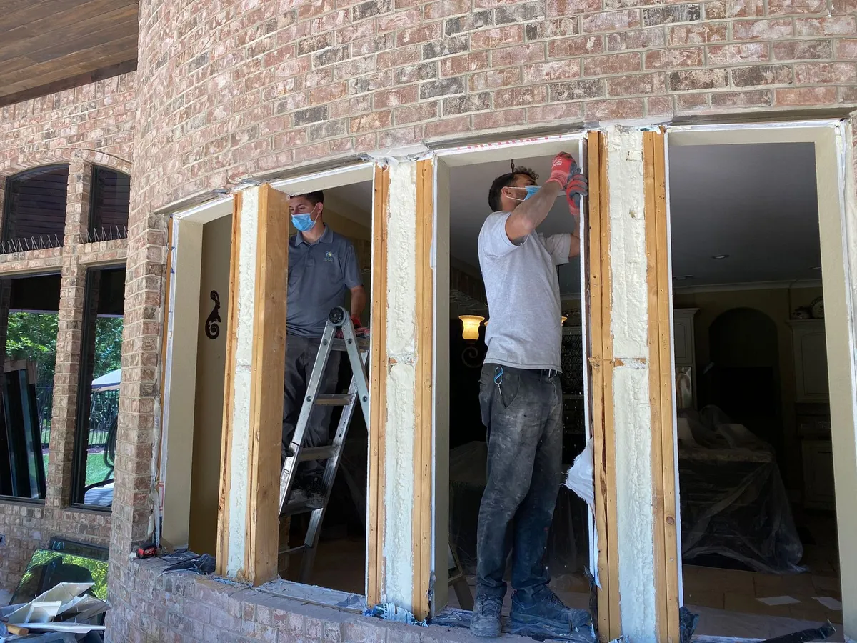 Window replacement crew removing old frames