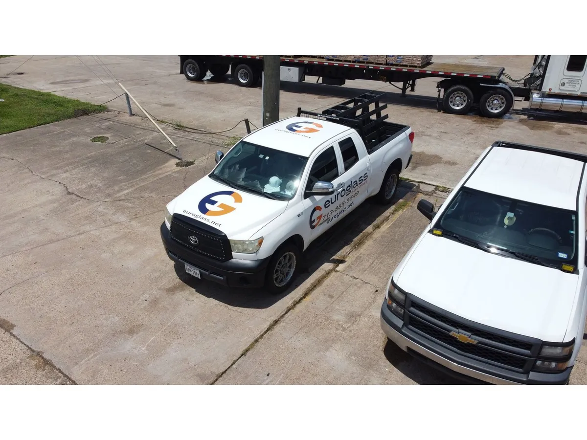Euro Glass branded work trucks at the shop