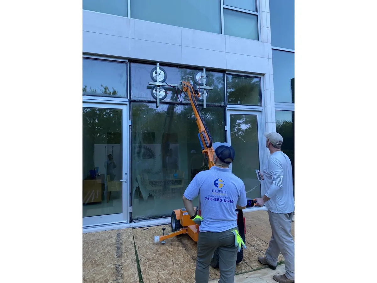 Crew installing glass on a commercial building