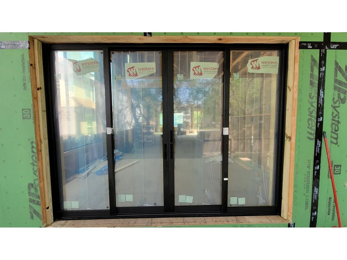 Four-panel sliding glass door during installation
