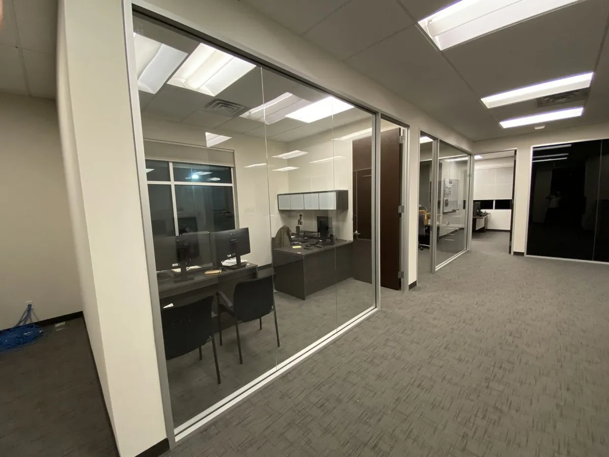 Frameless glass office front with Herculite door