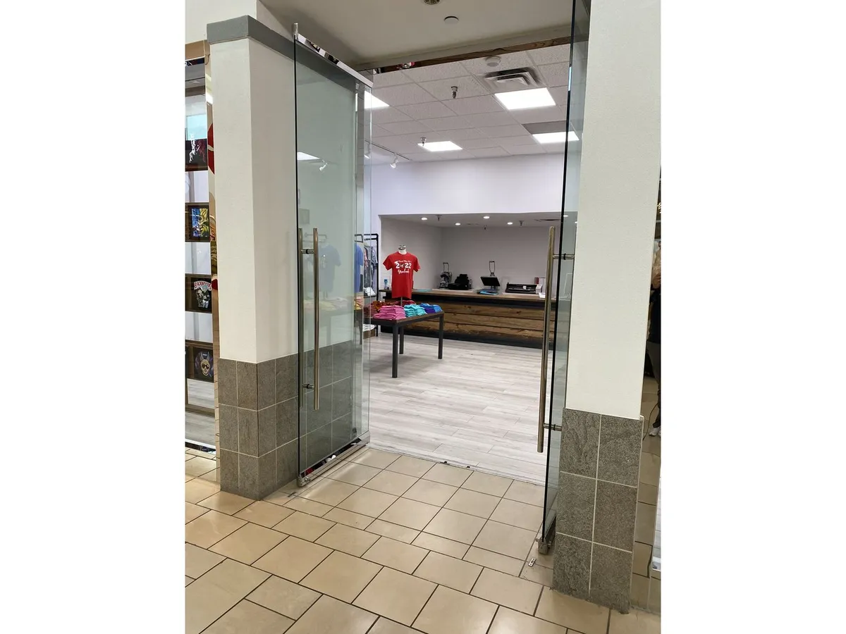 Frameless glass entry door in a retail space