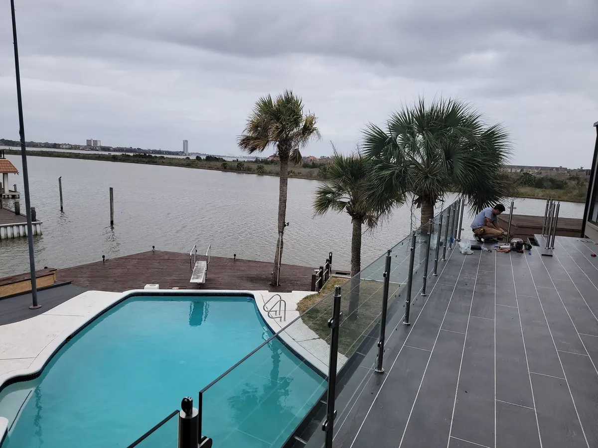 Frameless glass pool deck railing on the waterfront