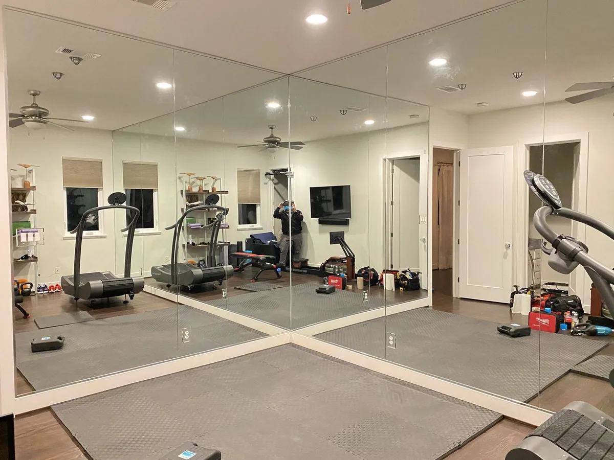 Floor-to-ceiling mirror wall in a home gym