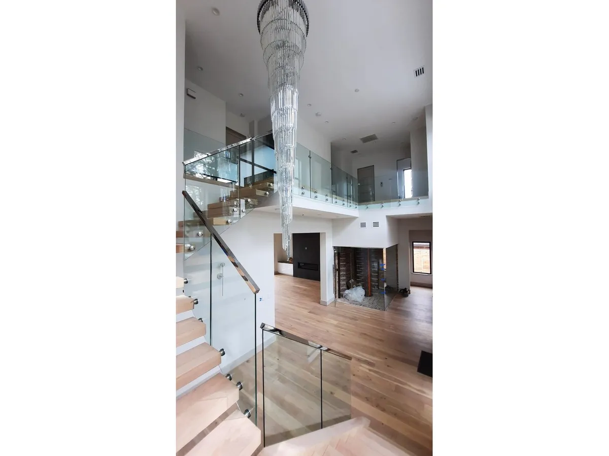 Glass railing on a two-story foyer staircase