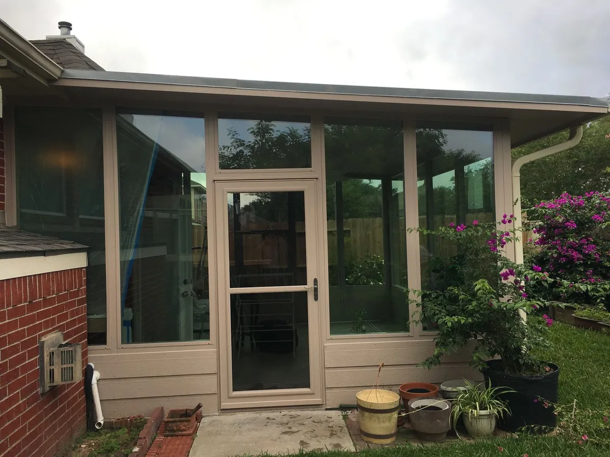 Glass sunroom addition with entry door