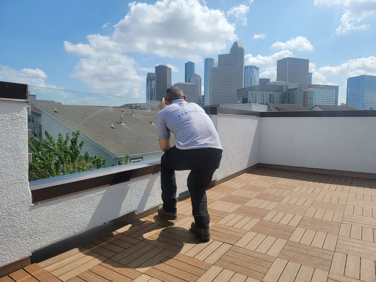 Installer working on a rooftop terrace railing