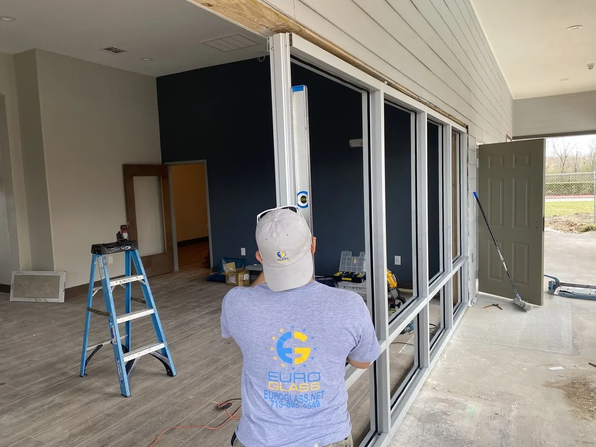 Euro Glass installer setting storefront glass