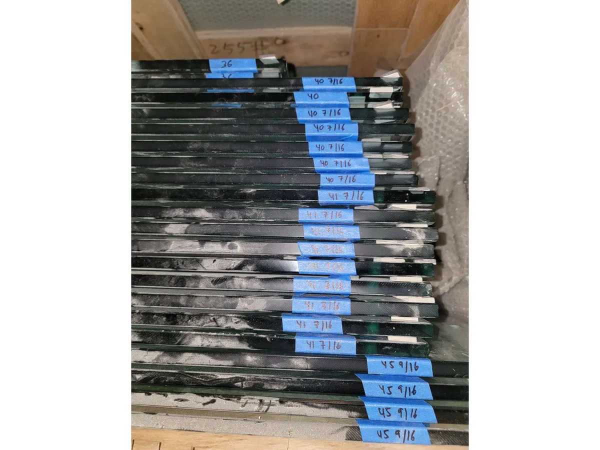 Labeled glass panels staged for a builder project