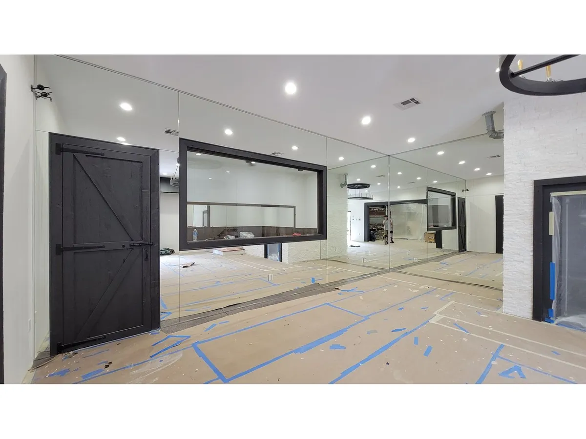 Large mirror wall installed in a modern room