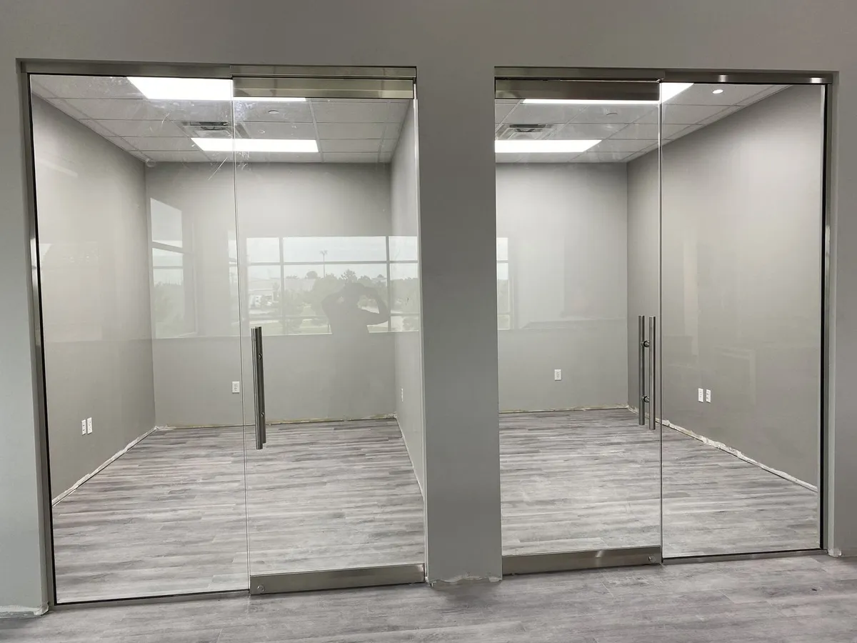 Pair of frameless Herculite glass office doors
