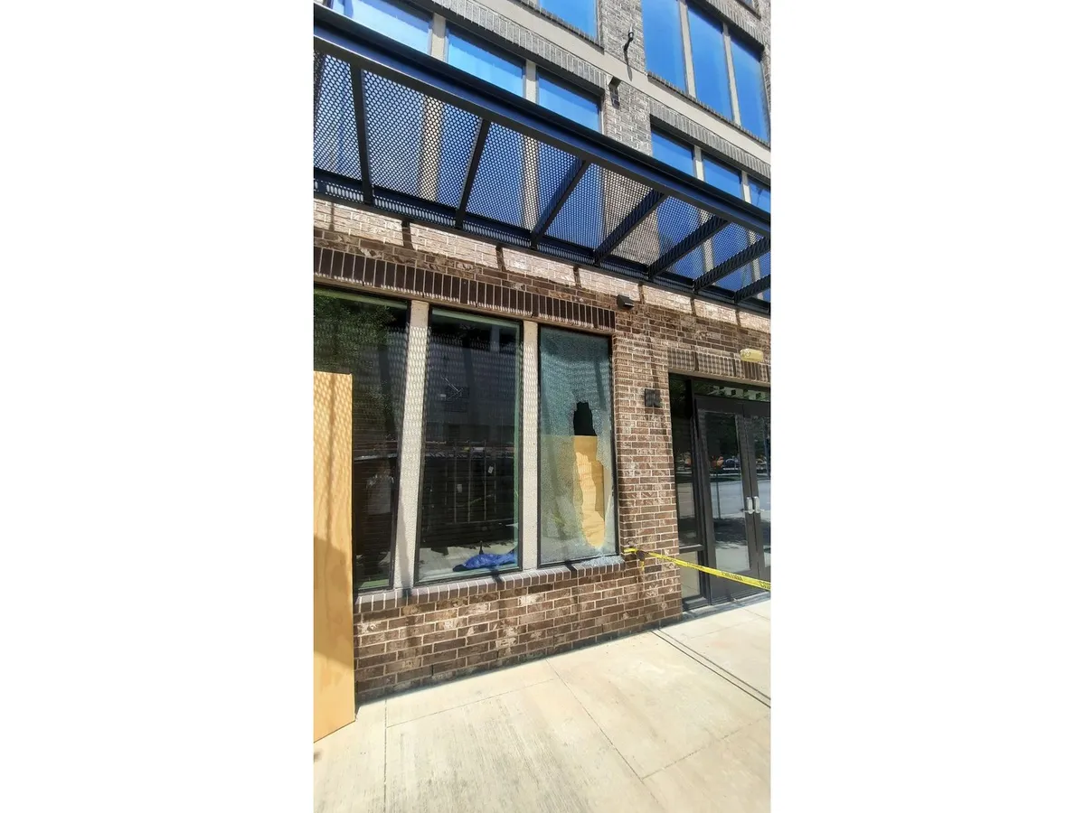 Storefront windows boarded up awaiting emergency glass replacement