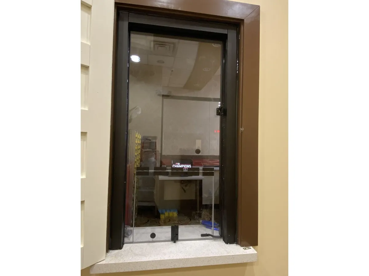 Secure glass teller window with pass-through tray