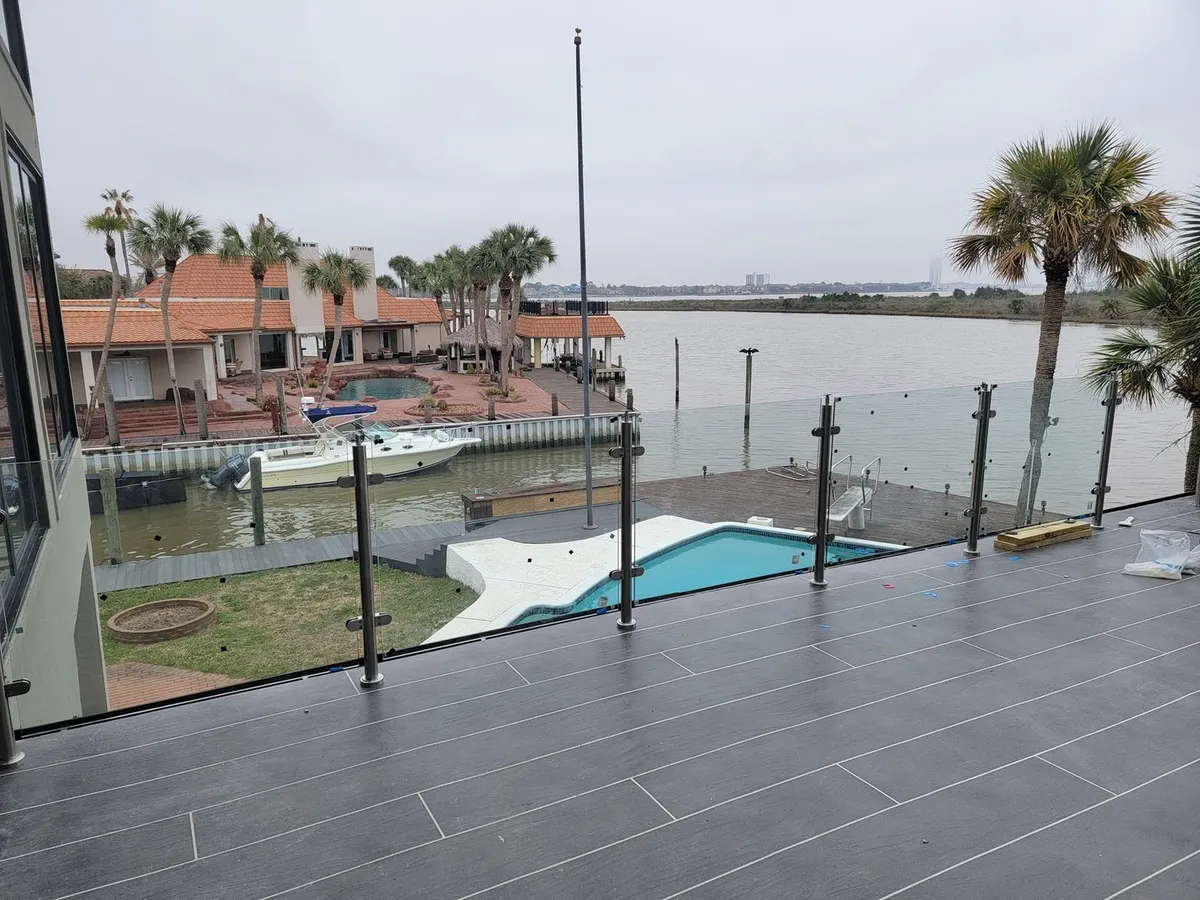 Frameless glass railing installed on a waterfront patio overlooking a Houston-area marina, Euro Glass project