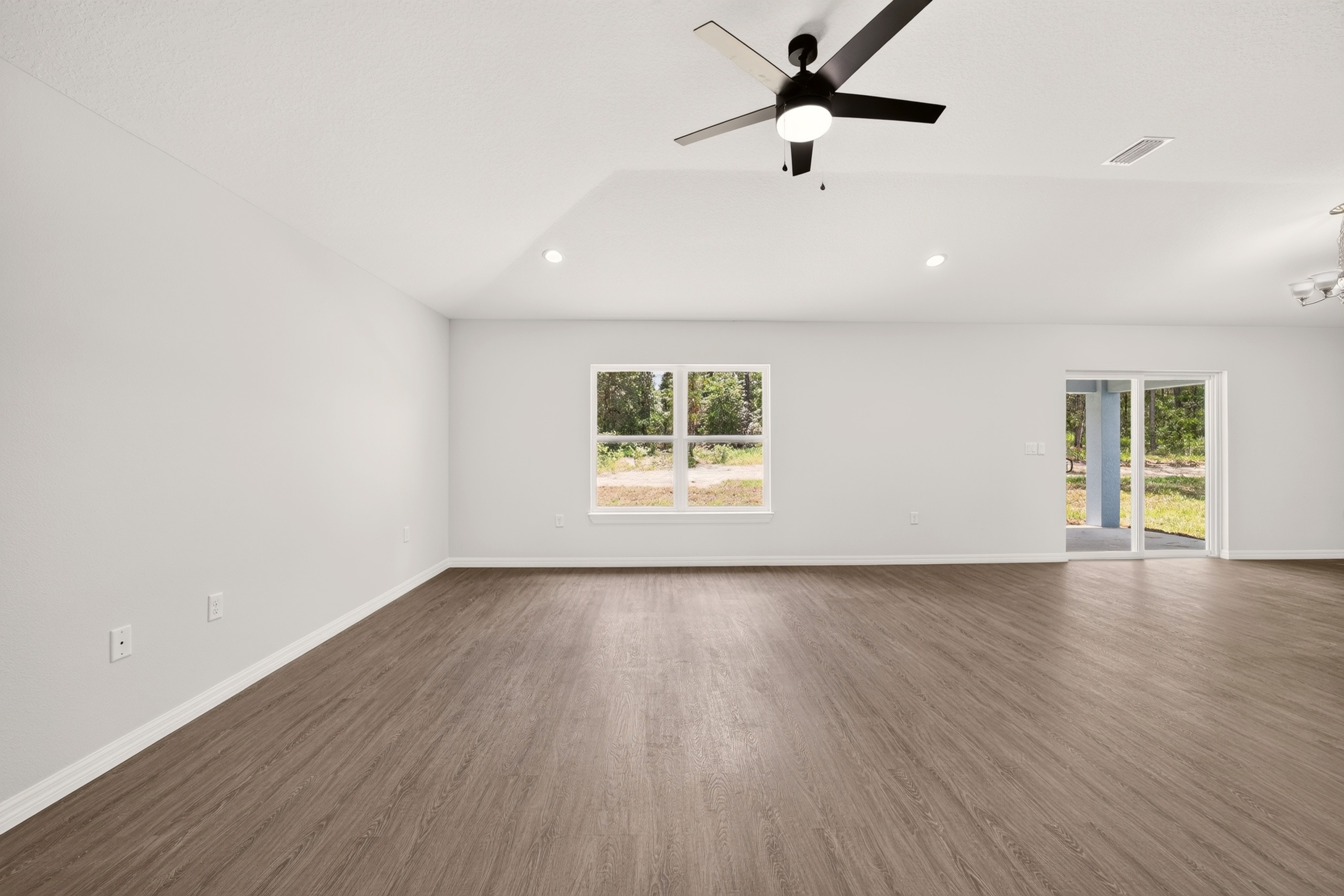 Modern open concept living room interior layout with grey flooring in the Timberland home plan