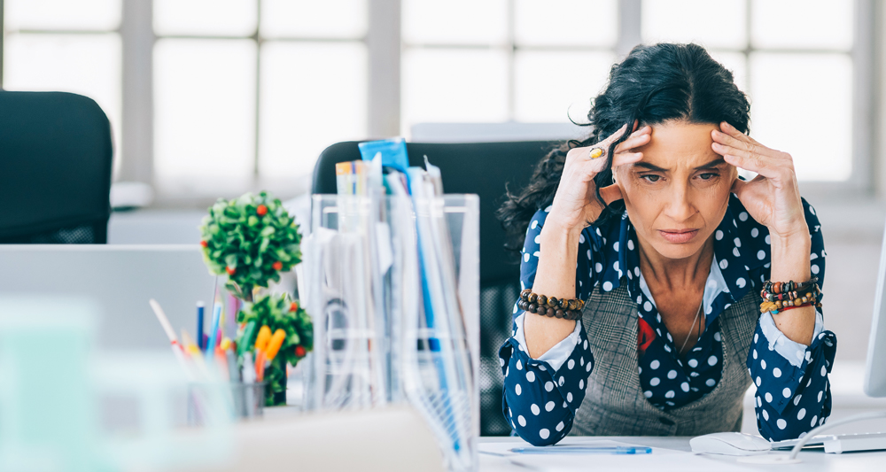 a group of people standing on a street with a crowd watching