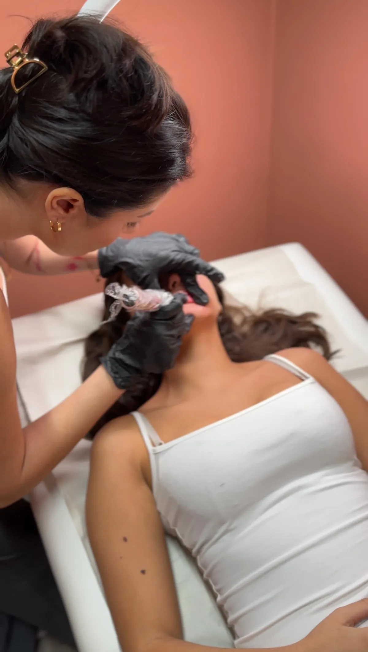 brown short coated dog lying on red and white textile