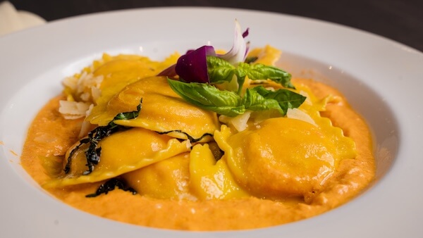 A zoomed out image of Lobster Ravioli in a lobster sauce
