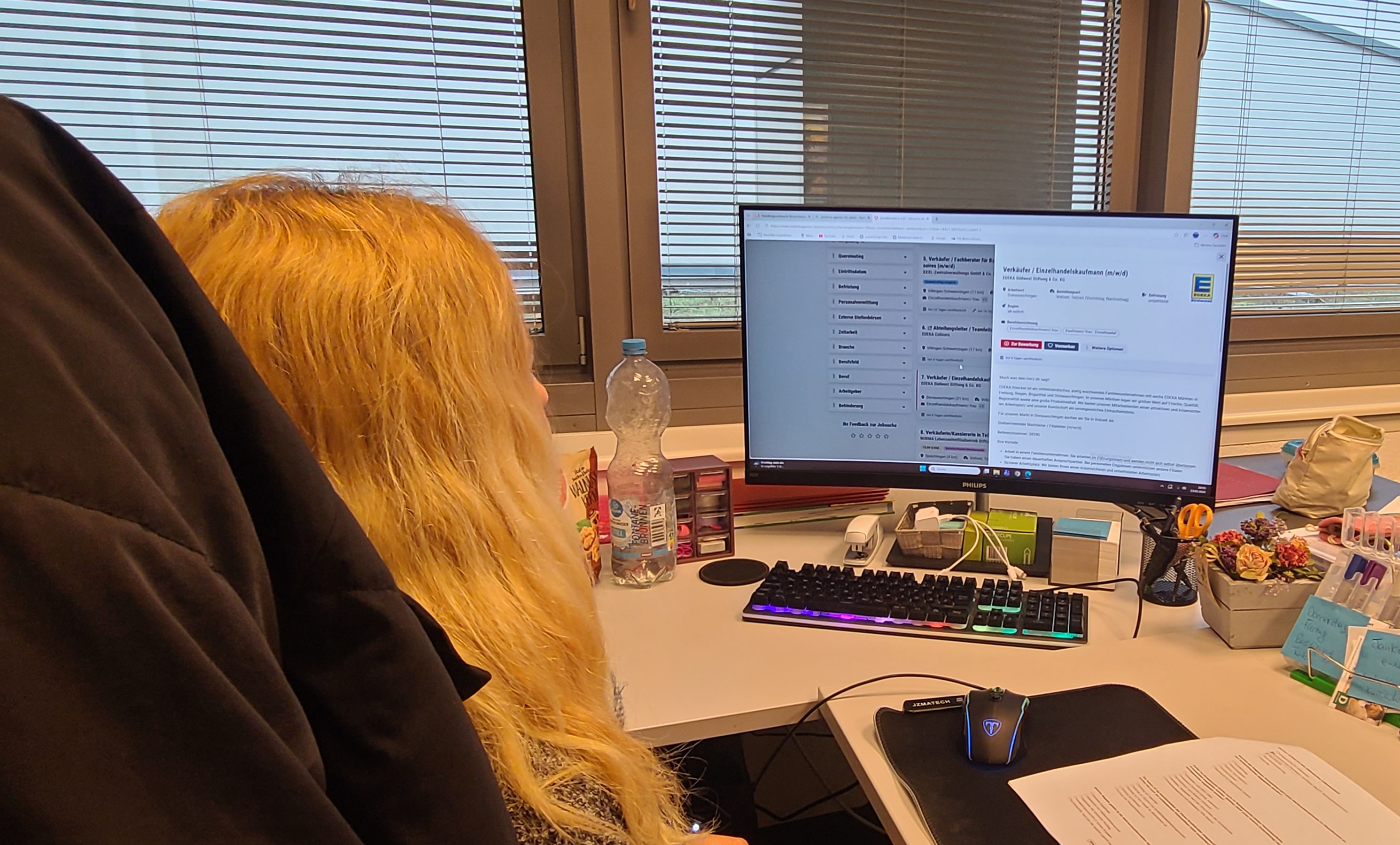Two businessmen collaborating on a laptop in an office.