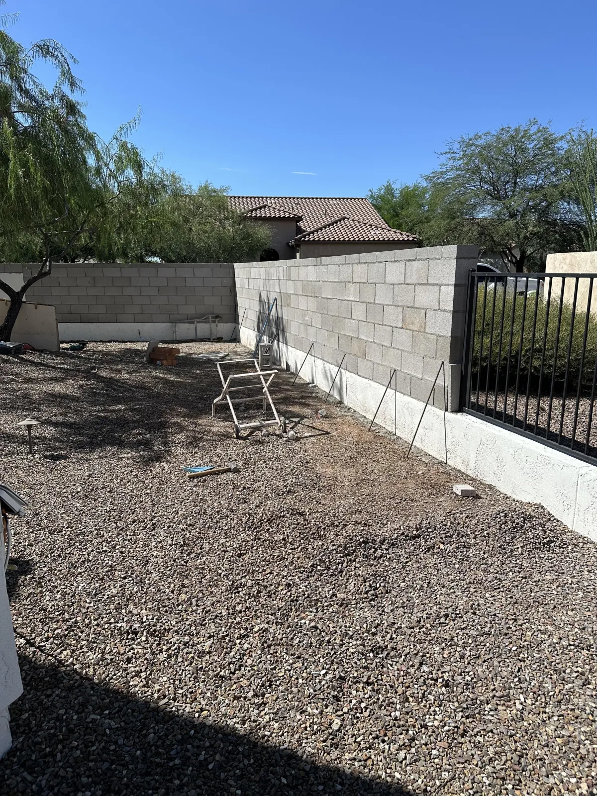 Gray block privacy wall constructed by Mundo Landscaping in Tucson, AZ — strong, clean, and long-lasting masonry installation.