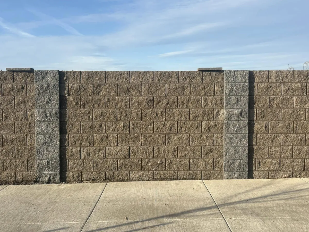 Cinder block retaining wall with textured finish built by Mundo Landscaping in Tucson, AZ — durable and modern masonry design.