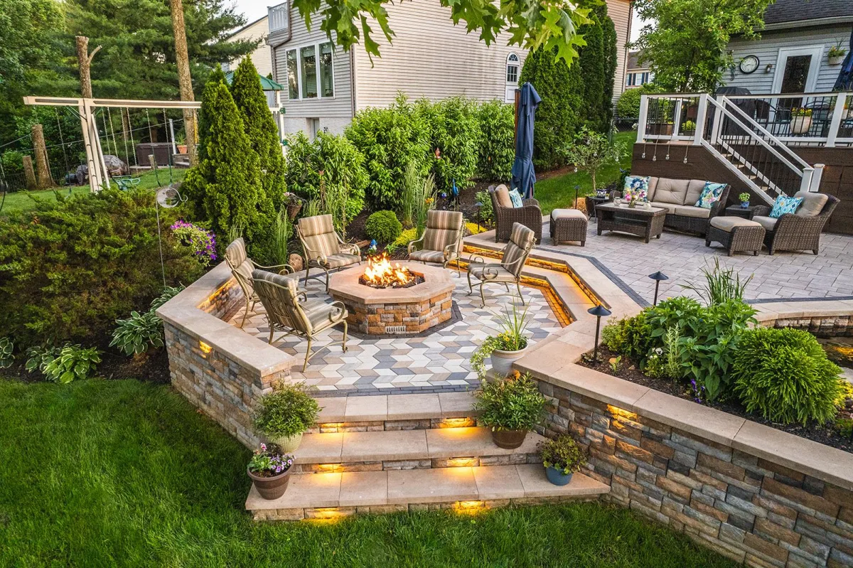 Backyard with circular paver patio, seating wall, and fire pit designed by Mundo Landscaping in Tucson, AZ — example of expert hardscape craftsmanship.