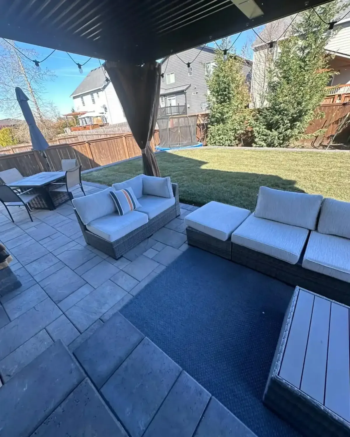 Paver patio with covered gazebo, outdoor seating, and manicured lawn installed by HD Landscape in Tualatin