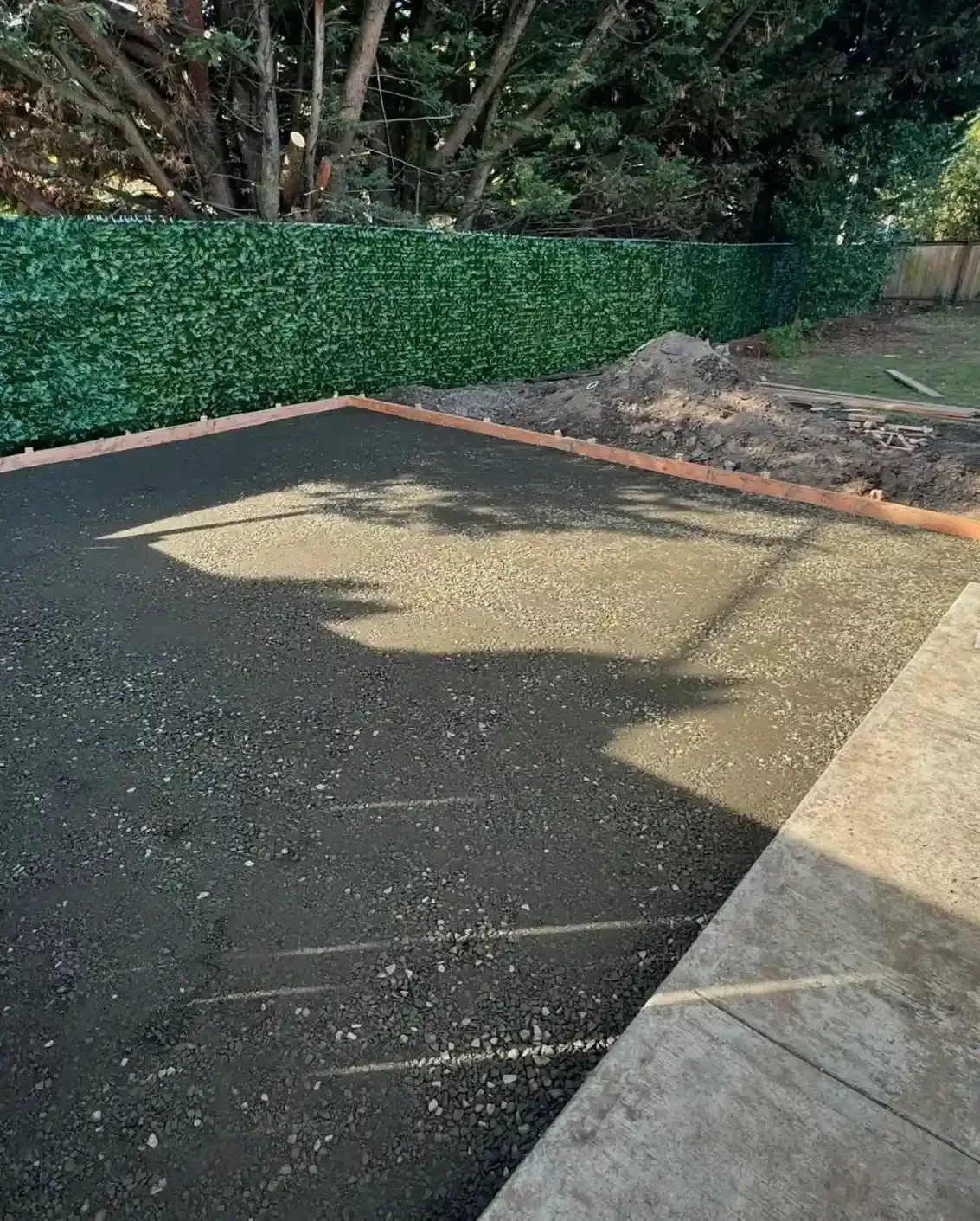 Compacted crushed gravel base with wood form boards ready for patio or turf installation by HD Landscape in Portland