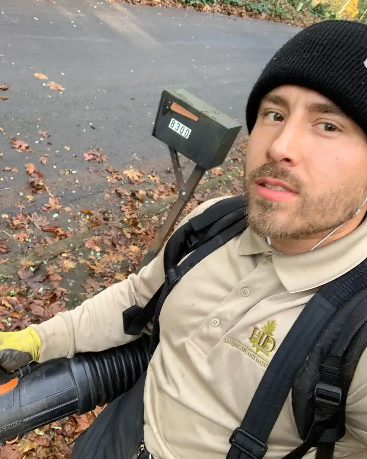 HD Landscape and Maintenance crew member with backpack leaf blower during a fall leaf removal job in Portland