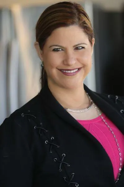 Professional headshot of Orly Amor smiling in a black blazer, featured alongside a list of personalized speaking business guidance benefits offered during the SWF Cruise 2025.