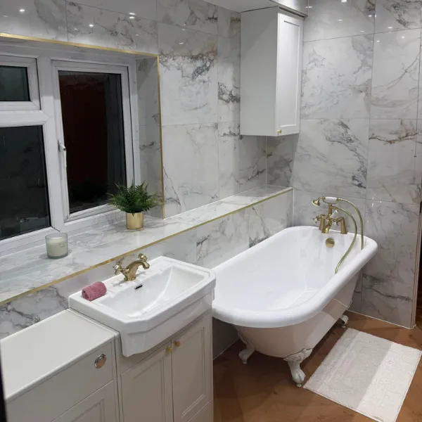 A marbled wall and roll top bath that our bathroom fitters installed in a house in Blackwood