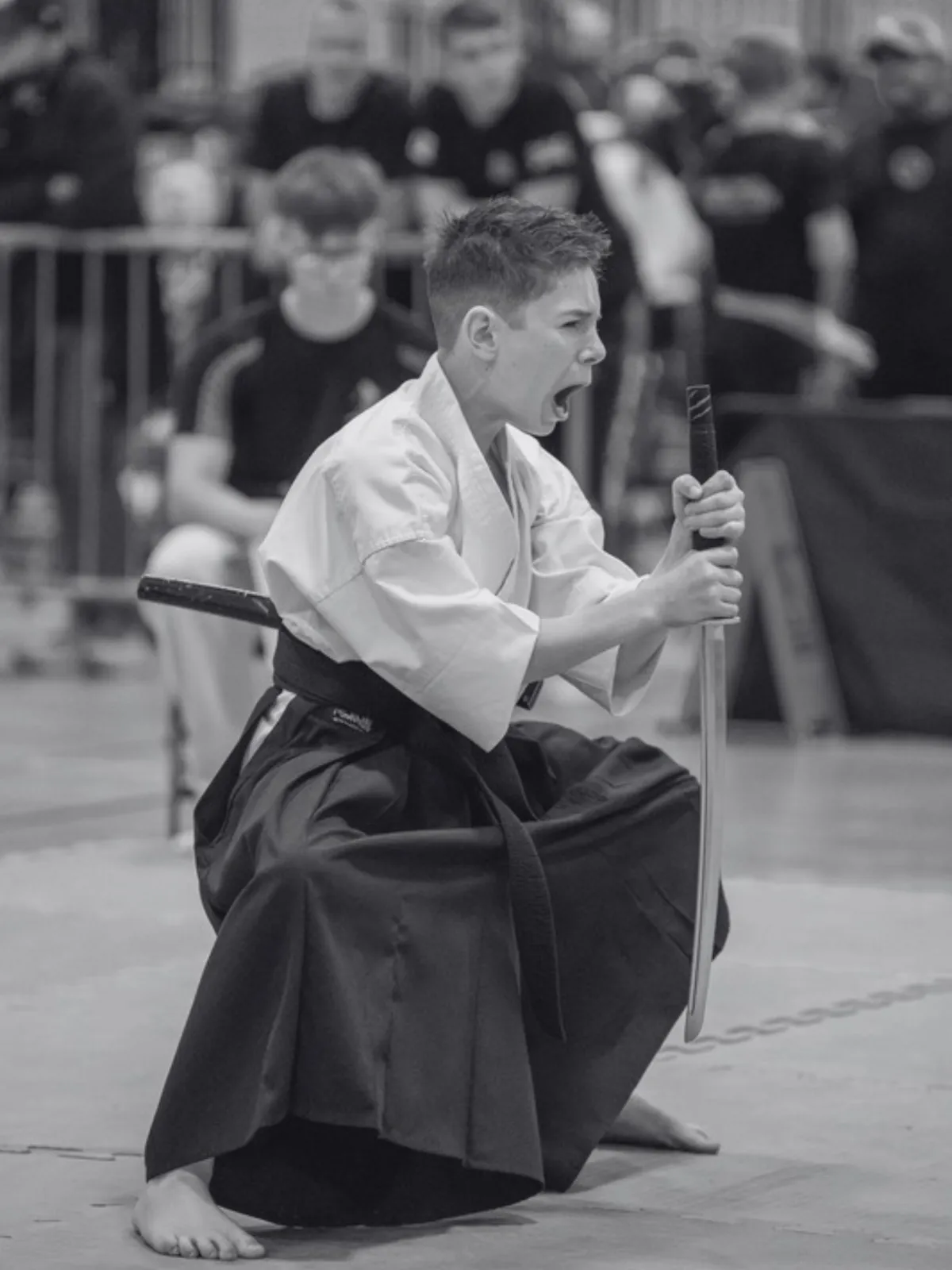 Tyler Killoran performing advanced martial arts weapons techniques