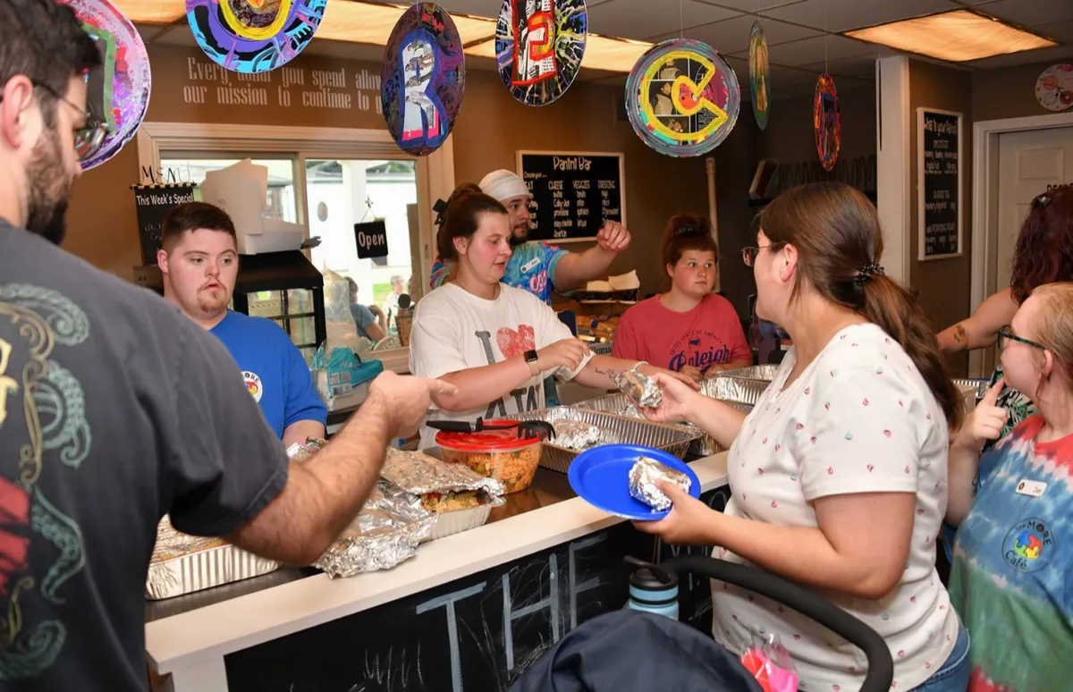 Volunteers and guests enjoy food and fellowship at a MORE Community Cafe celebration.