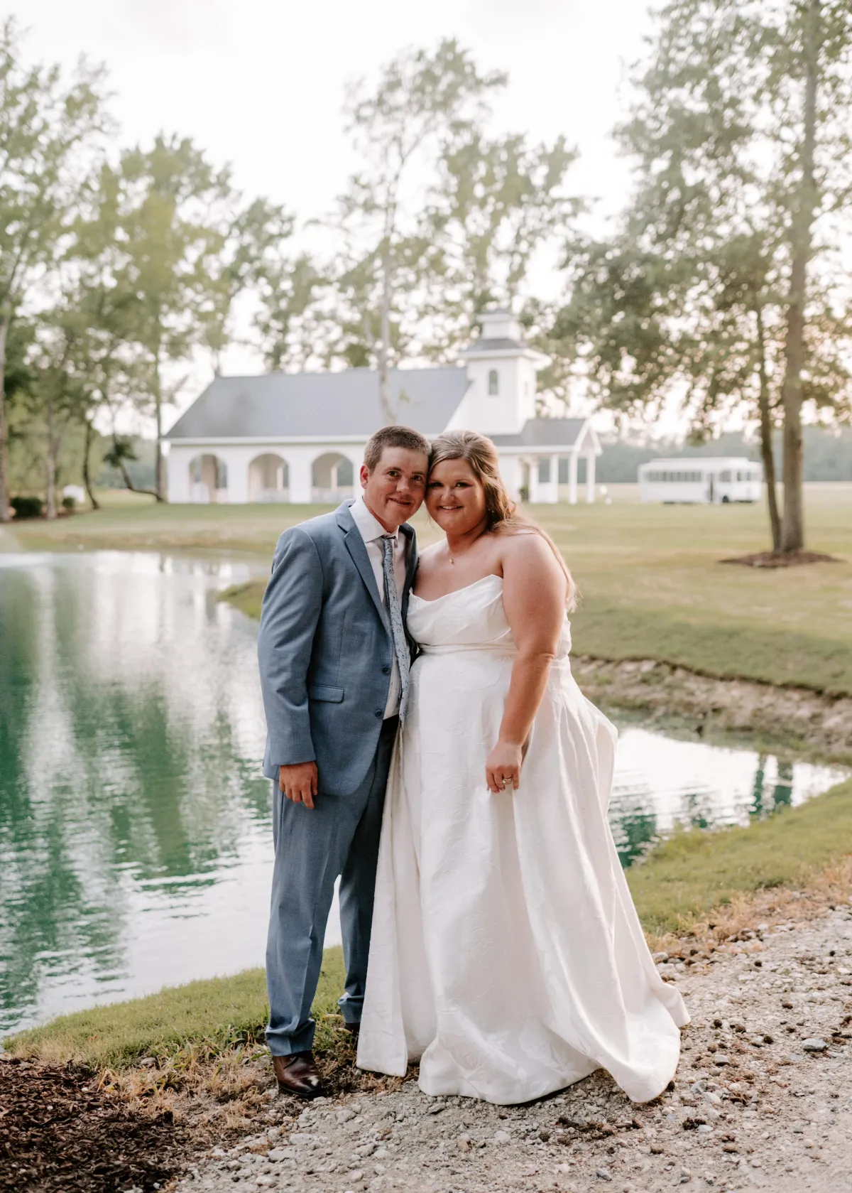 A wedding ceremony outdoors with a couple holding hands in front of a minister