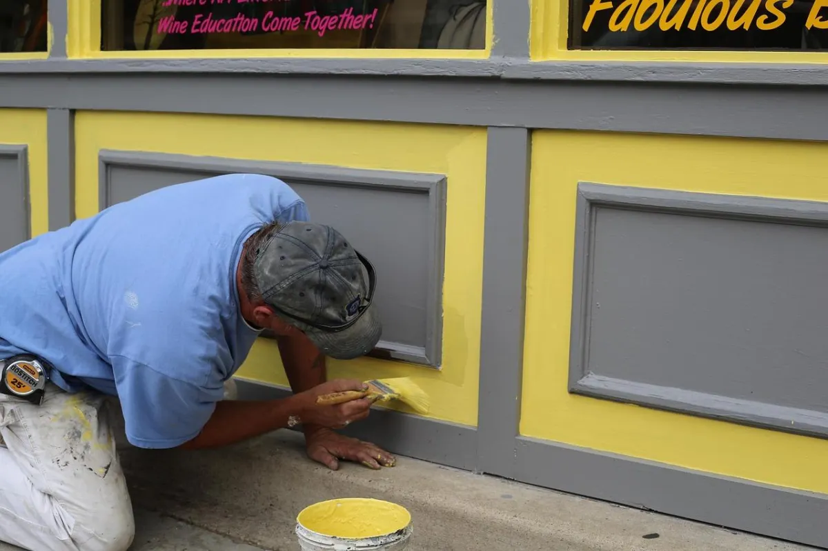 Professional exterior painting Lancaster PA contractor painting commercial building yellow gray trim