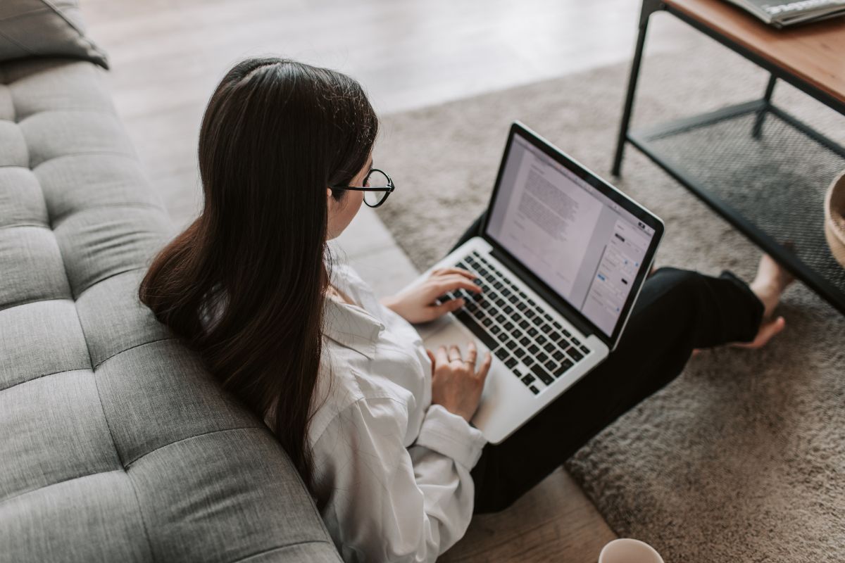 Woman using a laptop to make funeral arrangements online