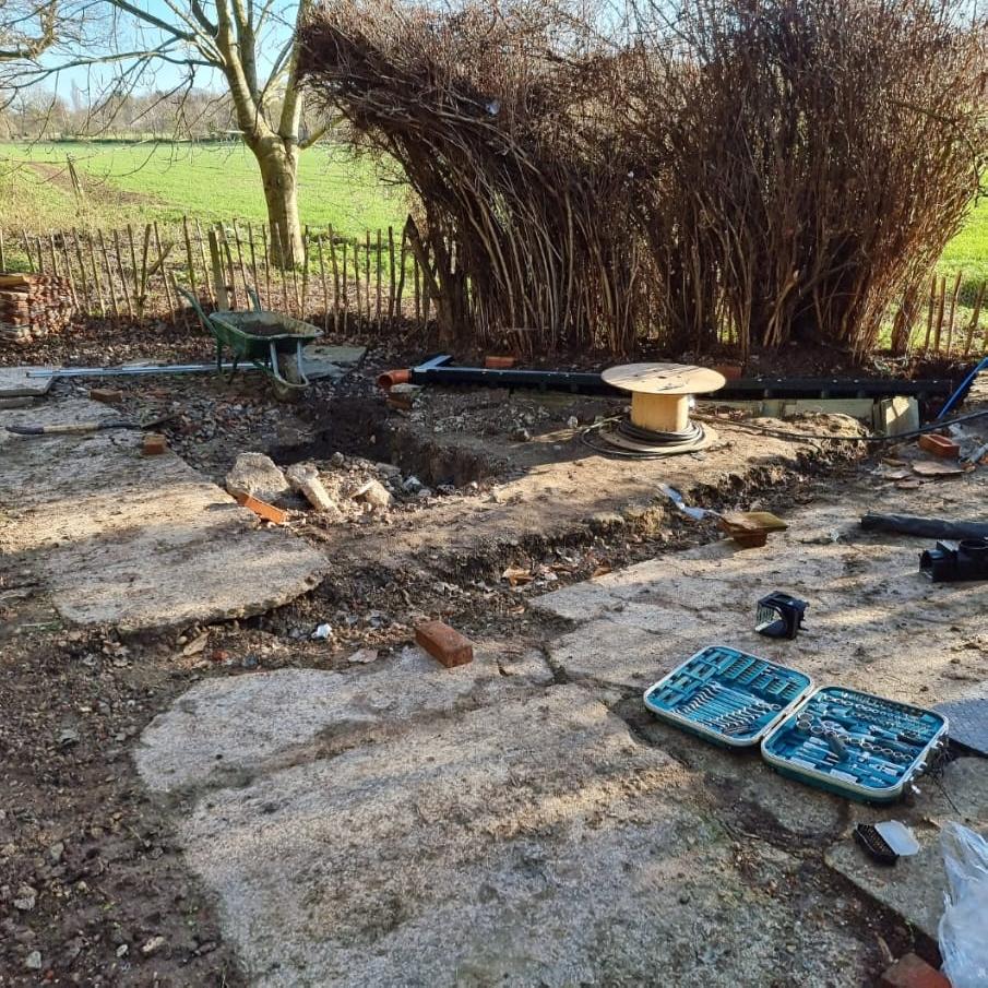Groundworks and excavation in Ipswich with a digger levelling a new driveway base
