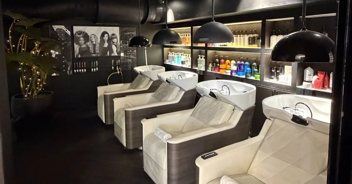 a hair salon with chairs and mirrors