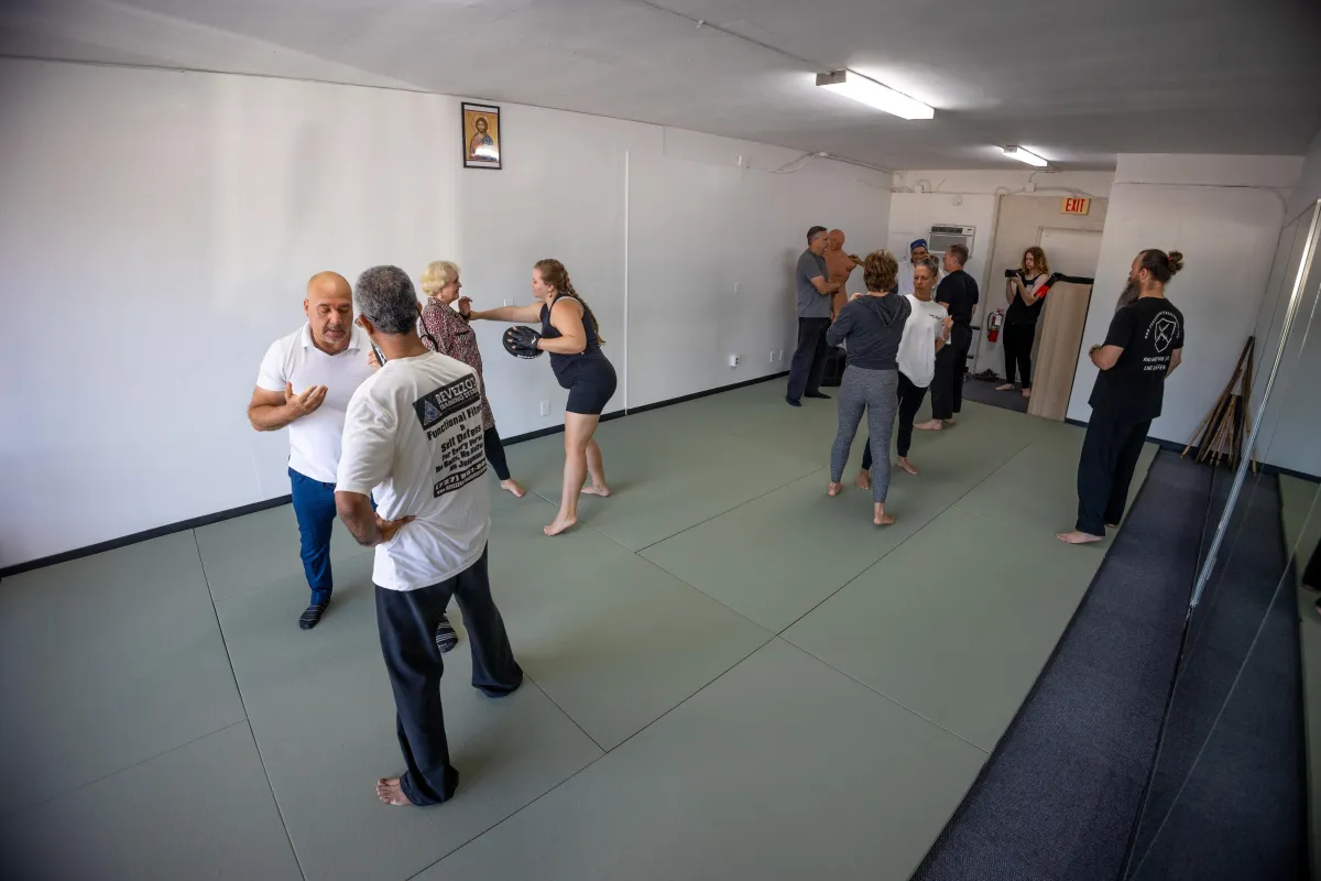 Self-defense training snapshot, instructor demonstrating balance disruption