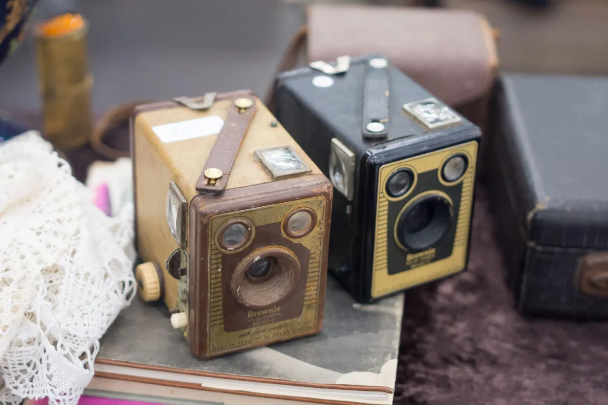 Two old antique cameras on a table