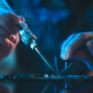 hands soldering electronics