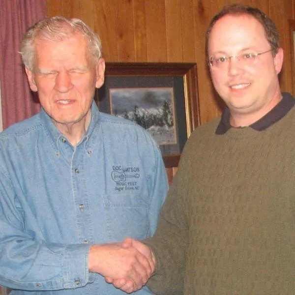 Tom shaking hands with Doc Watson